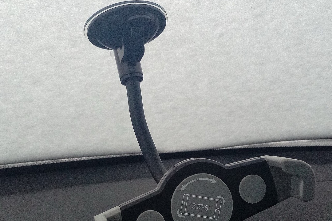 Smartphone mounted on a car dashboard vent holder showing navigation