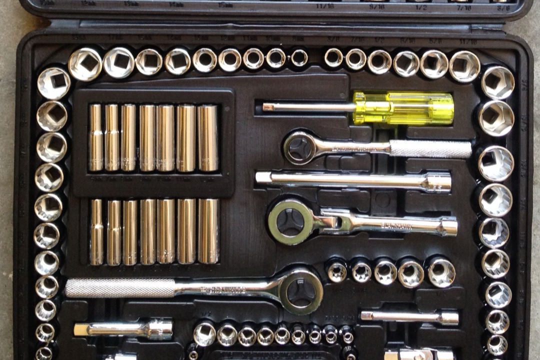 Complete mechanic tool set with sockets, ratchets, combination wrenches, and hex keys organized in a rolling shop chest