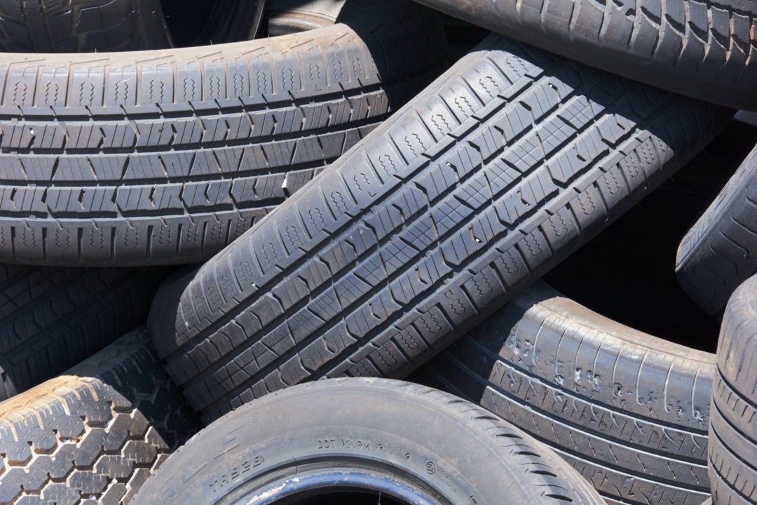 Stack of new passenger and light truck tires in an automotive shop, ready for installation