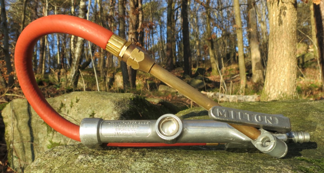 Close-up of a tire pressure gauge being used on a car tire valve stem